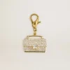 Colgante con forma de bolso de latón dorado con cristales