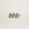 Accesorio de cordón con tres estrellas en color oro antiguo con cristales