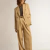 Americana de doble botonadura para mujer en color arena con botones heráldicos dorados