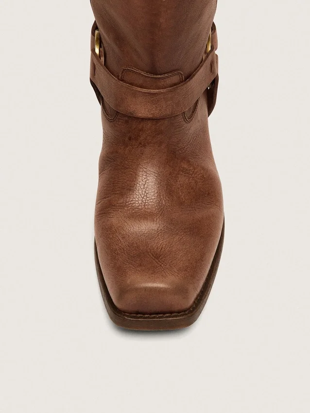 Botas moteras altas de mujer en piel marrón con correa y hebilla en color oro antiguo