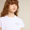 Camisas blancas y plateadas con logotipo y estrella grande con purpurina plateada
