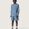 Camisas unisex «Journey» de cambray de algodón azul claro con bajo con flecos y parche bordado