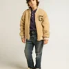 Chaqueta bomber infantil de forro polar en color beige