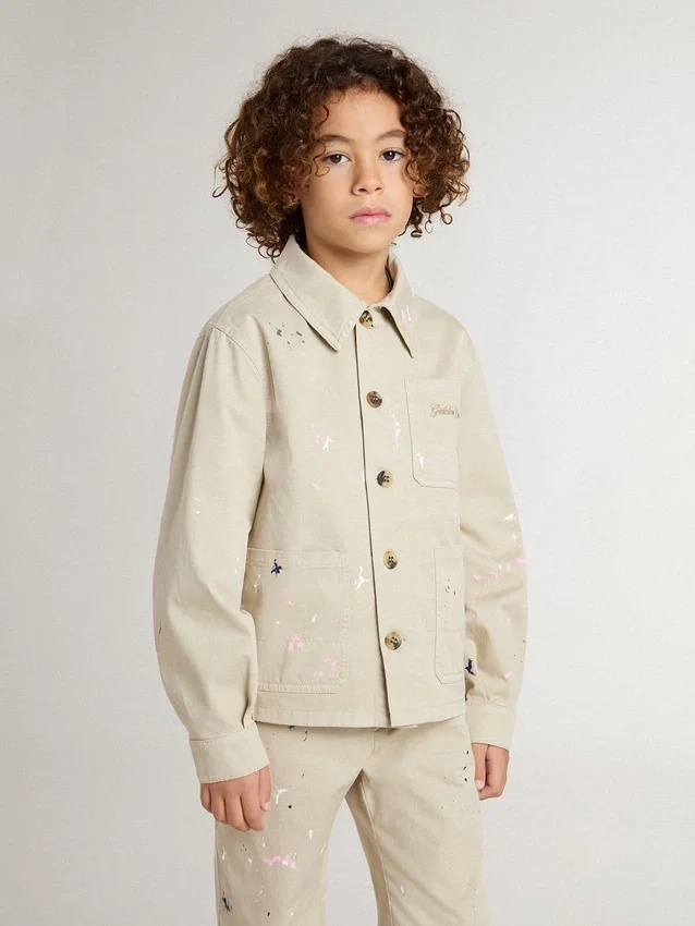 Chaqueta infantil de color beige con salpicaduras multicolores