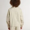 Chaqueta infantil de color beige con salpicaduras multicolores