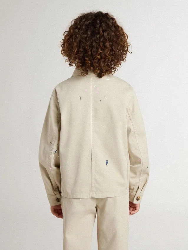 Chaqueta infantil de color beige con salpicaduras multicolores