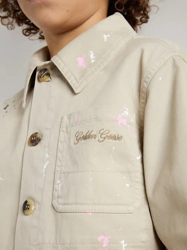 Chaqueta infantil de color beige con salpicaduras multicolores