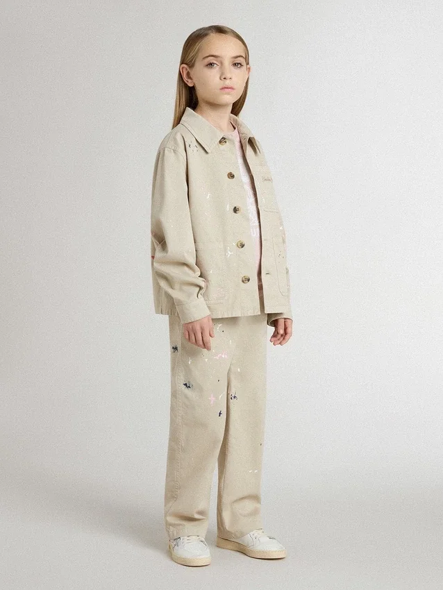 Chaqueta infantil de color beige con salpicaduras multicolores