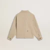 Chaqueta infantil de color beige con salpicaduras multicolores