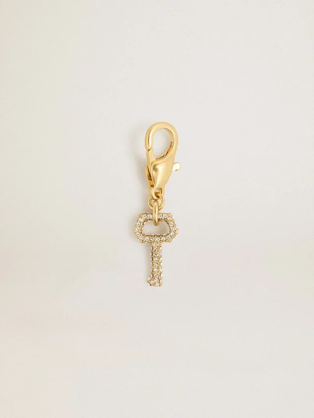 Colgante con forma de llave de latón dorado con cristales