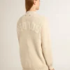Cárdigan beige de mujer con la inscripción «Golden» en la espalda