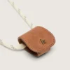 Estuche para gafas con una correa de senderismo de color crema y un clip de cuero de color tostado