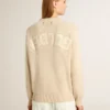 Jersey beige de mujer con la inscripción «Golden» en la espalda