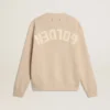 Jersey beige de mujer con la inscripción «Golden» en la espalda