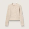 Jersey corto de cuello redondo en lana beige con cristales por toda la prenda