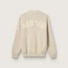 Jersey unisex de cuello redondo de algodón beige con parche en la parte delantera y logotipo en la espalda