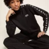 Sudadera negra con cremallera para mujer y estrellas blancas