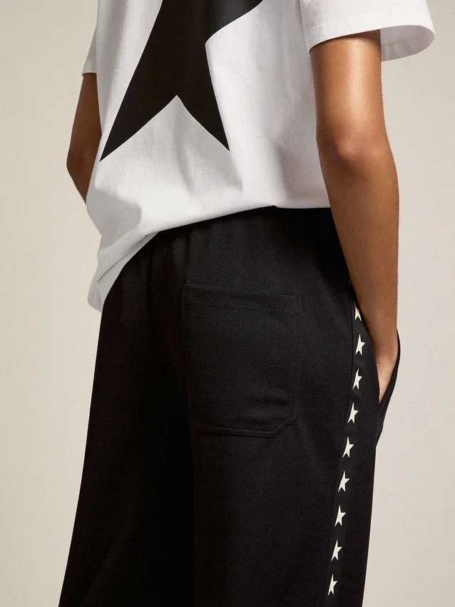 Pantalones de chándal negros de mujer con estrellas blancas en los laterales