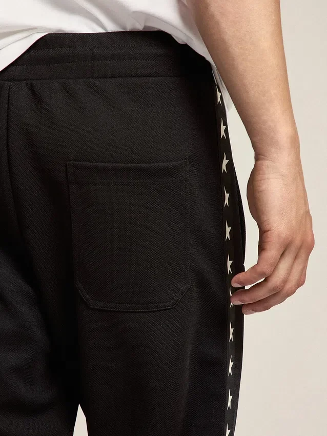 Pantalones de chándal negros para hombre con estrellas blancas en los laterales