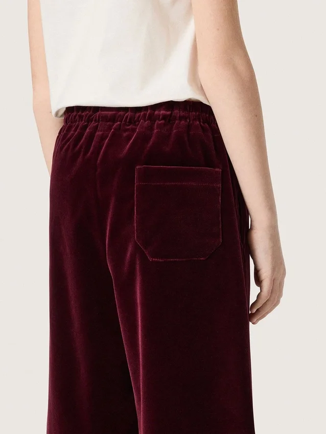 Pantalones de efecto terciopelo burdeos para niñas con bolsillo trasero
