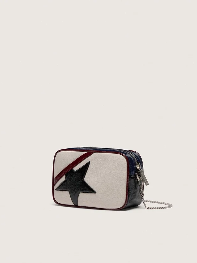 Star Bag Mini en piel blanco mantequilla con estrella negra y detalles en burdeos y azul oscuro