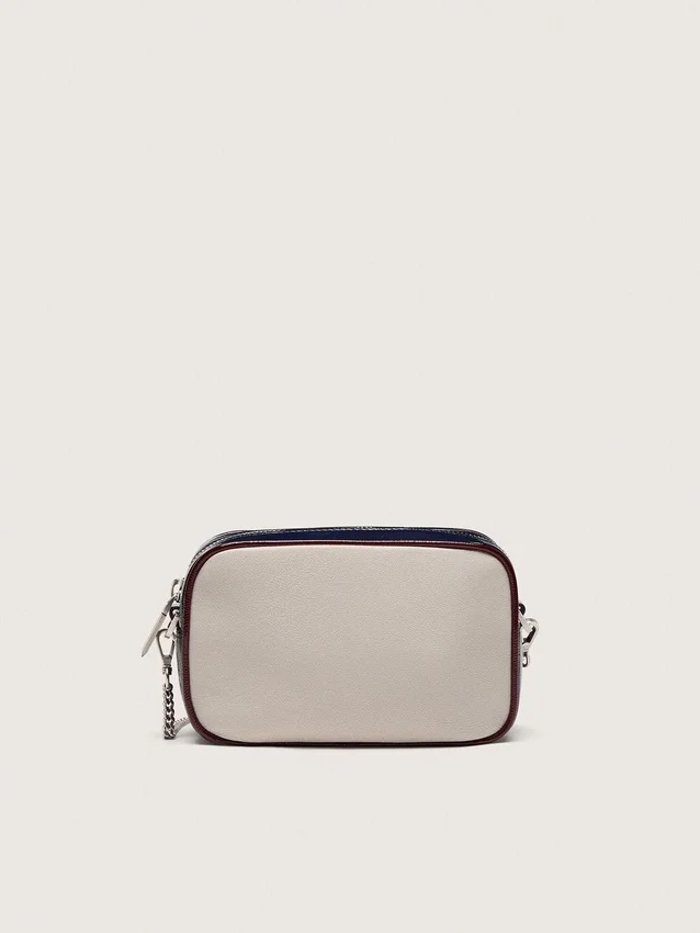 Star Bag Mini en piel blanco mantequilla con estrella negra y detalles en burdeos y azul oscuro