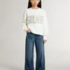Sudadera blanca para niñas con letras doradas multicolores en la parte delantera