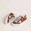 Super-Star para hombre en ante rojo ladrillo con estrella de piel blanca y lengüeta en el talón con estampado animal