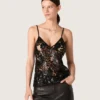 Top de mujer de tul negro con estampado floral de lentejuelas negras
