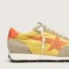 Zapatillas Marathon para mujer con parte superior de nailon amarillo y estrella naranja