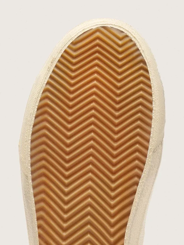 Zapatillas Slide en color beige con estrella y detalle brillante de piel metalizada rosa